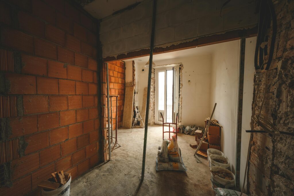pexels photo 15798781 15798781 A partially renovated room with exposed brick walls and construction materials on site.